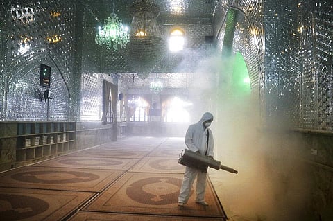 A firefighter disinfects the shrine of Saint Saleh to help prevent the spread of the new coronavirus in northern Tehran, Iran. (Photo | AP)