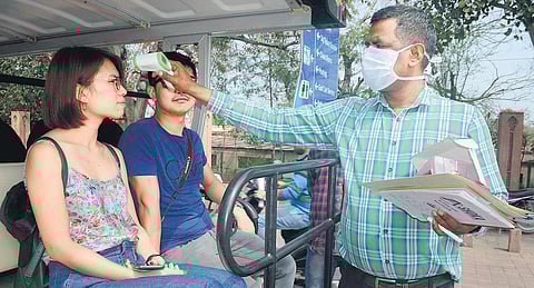 An official uses a thermal screening device on tourists in the wake of deadly Coronavirus outbreak, on Thursday in Agra. (Photo | PTI)
