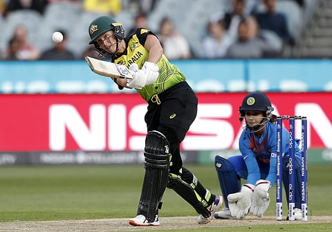 Australia's Alyssa Healy, left, drives the ball in front of IndiaÅfs Tanya Bhatia during the WomenÅfs T20 World Cup cricket final match against India in Melbourne, Sunday, March 8, 2020. (Photo | AP)