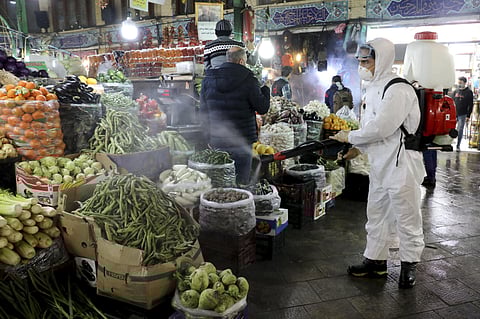 A firefighter disinfects a traditional shopping center to help prevent the spread of the new coronavirus in northern Tehran. (Photo | AP)