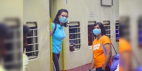Passengers wear protective masks at the Bengaluru railway station. (Photo | Pandarinath B, EPS)