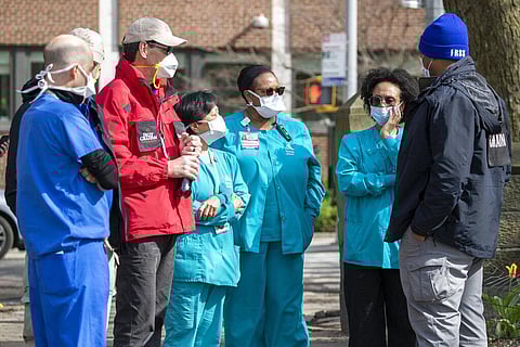 Medical personnel talk to chaplains, left, as they tour the Samaritan's Purse 68 bed emergency field hospital especially equipped with a respiratory unit in New York's Central Park, Tuesday, March 31, 2020, in New York. (Photo | AP)