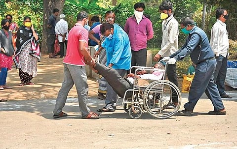 A man with withdrawal symptoms being brought on a wheelchair by his family members to Erragadda Mental Hospital in Hyderabad on Tuesday (Photo | R V K Rao, EPS)