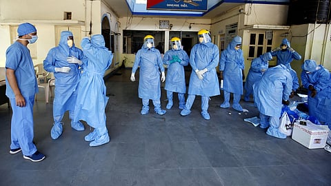 Doctors wearing protective suits before they start collecting swab from people, who are under home quarantine to test for COVID-19. (File photo| ANI)