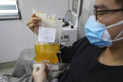 A recovered COVID-19 patient who has passed his 14-day quarantine, donates plasma in the city's blood center. (Photo | AP)