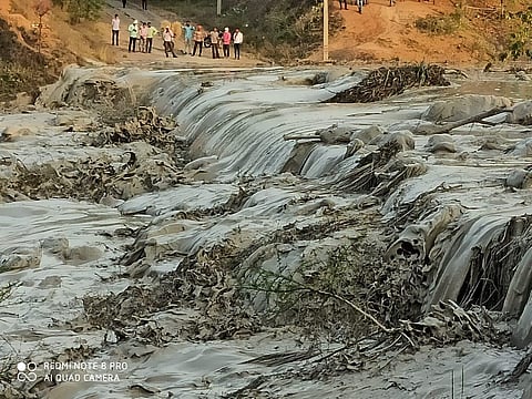 Picture of the toxic fly ash slurry after the dyke collapse and one of the two bodies retrieved