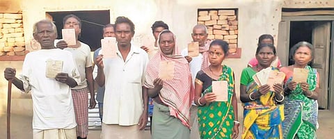 Sarojmatu villagers display their PDS cards which was till recently with money lenders | Express