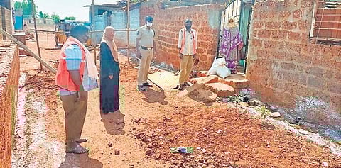 Anganwadi teacher Waseema Begum interacting with a slum-dweller in Zaheerabad on Friday