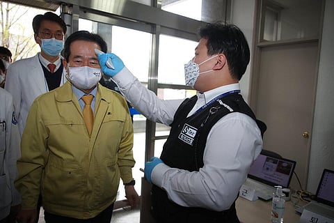 South Korean Prime Minister Chung Sye-kyun has his temperature checked upon his arrival at Dongsan Medical Center in Daegu, South Korea. (Photo | AP)