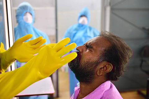 Health workers busy taking nasal swabs through from people through a covid-19 sample collection kiosk that have been installed at Public Health Laboratory and Health Care Center at Pudupet in Chennai on Saturday. (Photo | Debadatta Mallick/EPS)