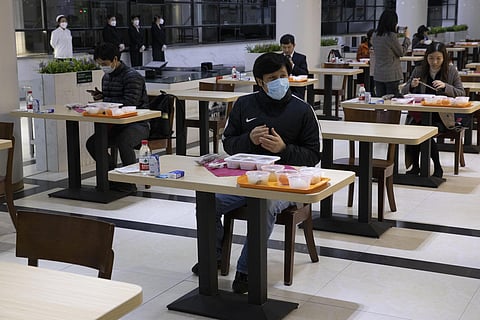 Visitors eat their meals spaced apart at the Wuhan University in Wuhan in central China's Hubei province on Saturday, April 11, 2020. (Photo | AP)