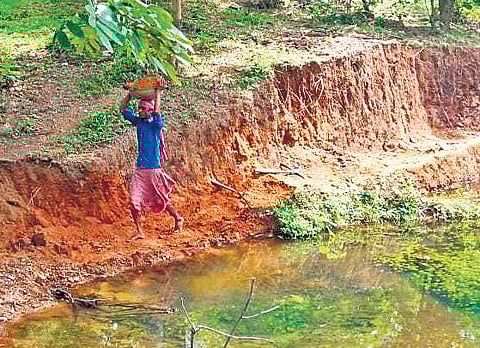 Ansari and his wife working to complete the check dam