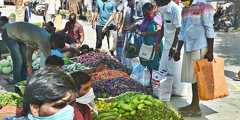 Unaware of the risks of COVID-19, people are seen disobeying the government rules by standing closer to one another for buying vegetables at a market near Tambaram camp road. (Photo| Ashwin Prasath, EPS)