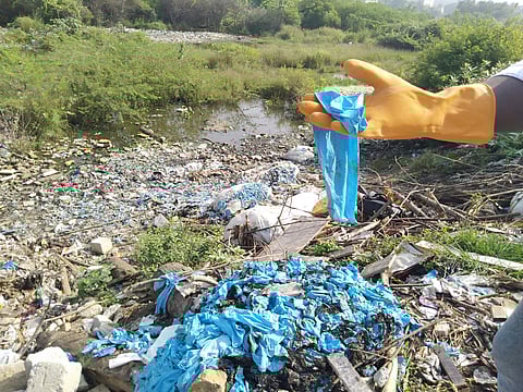 Close to ten sacks of used gloves were found half burnt. (Photo | EPS)