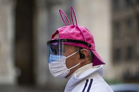 A man wearing bunny ears and face mask records stands in front of the Saint Patrick Cathedral on Easter Sunday, April 12, 2020 in New York City. (Photo | AFP)