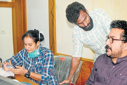 Gokulam Kerala FC coach Priya PV (L) with footballer CK Vineeth (C) in Kannur