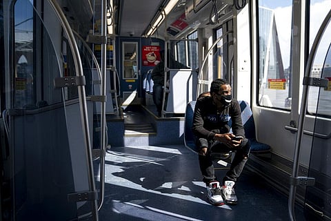 A rider on an almost empty Light Rail during the p.m. rush hour to meet someone in Minneapolis, Monday, April 13, 2020, during the coronavirus outbreak. (Photo |AP)