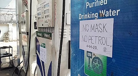 No mask no petrol' poster seen at a petrol pump in the Serampore area of Hooghly near Kolkata. (File photo| ANI)