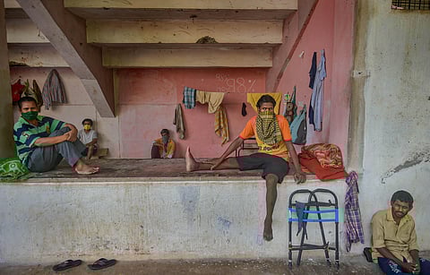Migrant workers and homeless people rest at a temporary camp set up on the premises of a stadium during ongoing COVID-19 lockdown in Thane Wednesday. (Photo | PTI)