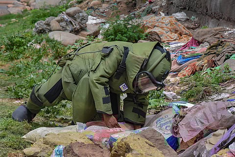 A member of Bomb Disposal Squad of the Indian Army neutralises a live mortar shell which was found lying unexploded near a residential area in Mendhar town of Poonch district Wednesday. (Photo | PTI)