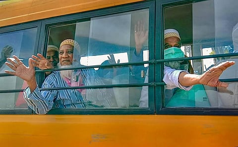 Pakistani nationals wave at media before crossing the Attari international border for their country at Attari near Amritsar Thursday. (Photo | PTI)