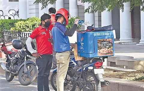 Delivery personnel go through their packages at Connaught Place | Parveen Negi