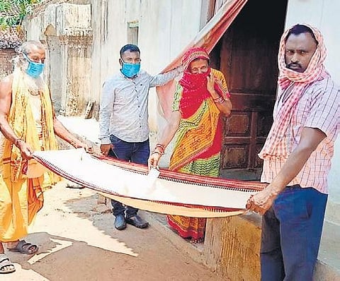Villagers collect donation from a woman
