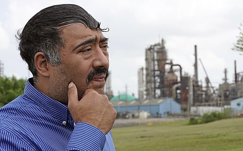 Juan Flores pauses while poses for a photograph while standing in a small park near a refinery along the Houston Ship Channel Monday, March 23, 2020, in Houston. (Photo | AP)