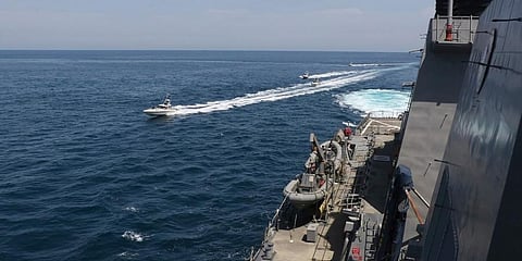Photo made available by US Navy shows Iranian Revolutionary Guard vessels sail close to U.S. military ships in the Persian Gulf near Kuwait. (Photo | AP)