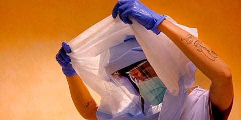 A nurse dresses up to enter the intensive care unit of the COVID-19 department of the Policlinic of Tor Vergata in Italy's Rome. (Photo | AP)