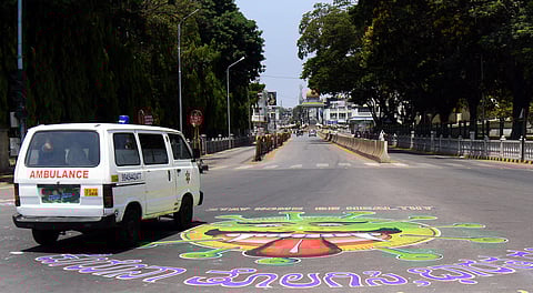 A huge COVID-19 awareness art work was drawn near Chamaraja circle by Mysuru Kuncha Kalavidara Sangha in Mysuru on Thursday. (Photo | Udayashankar S/EPS)