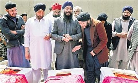 Afghan Sikh men mourn their beloved ones during a funeral procession in Kabul | AP