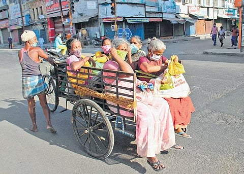 A group of women are seen traveling in a tricycles to get essential commodities at Simmakkal in Madurai on Wednesday | k k sundar