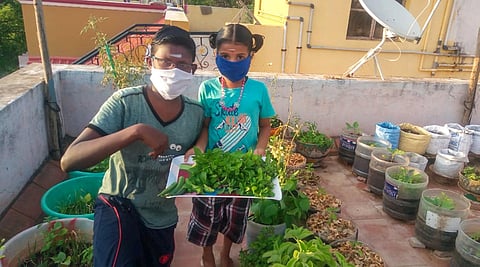 Residents with masks posing at the rooftop gardens in their houses in Tiruchy.(Photo| EPS)