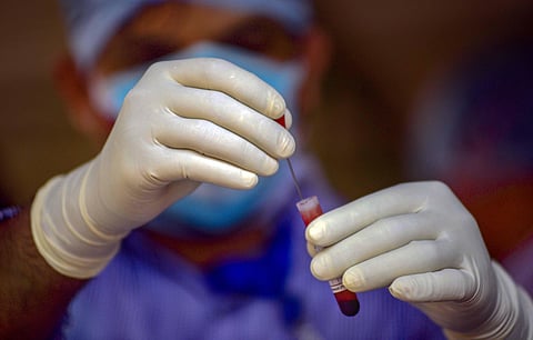 A medic works on a sample for COVID-19 Rapid Test at a camp during the nationwide lockdown imposed in a bid to contain the spread of coronavirus. (Photo | PTI)