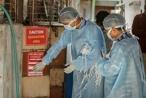 Medics paste stickers outside the houses of COVID-19 suspects during a nationwide lockdown to slow the spreading of coronavirus in Ahmedabad Sunday April 19 2020. (Photo | PTI)