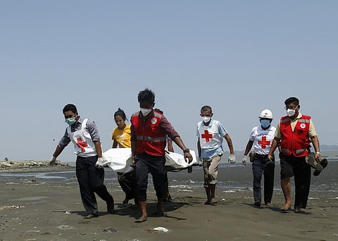 Members of the Myanmar Red Cross carry a dead body of a driver from a boat in Sittwe, Rakhine State on April 21, 2020 killed while delivering test kits for COVID-19 coronavirus. (Photo | AFP)
