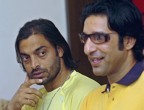 Shoaib Akhtar (L) watches as former teammate Wasim Akram addresses media representatives. (Photo | AFP)