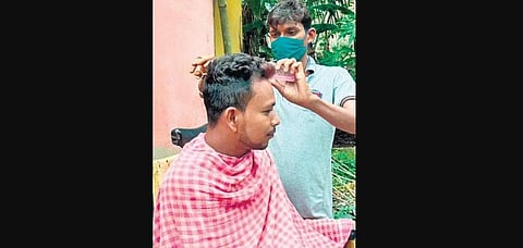 A barber giving a haircut to a villager