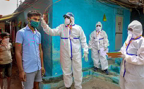 A team of doctors wearing protective suits check slum dwellers during a house-to-house health survey at Vallabh Nagar during the nationwide lockdown imposed in wake of the coronavirus pandemic in Bhopal Monday April 20 2020. (Photo | PTI)