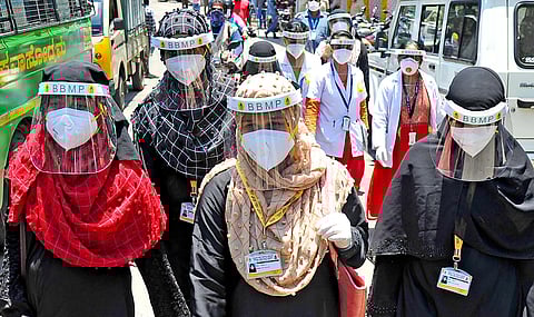 BBMP health workers go around Padarayanapura in Bengaluru on Monday, a day after the area witnessed violence | Pandarinath B