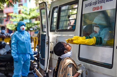 A health worker collects samples for a swab test of a policewoman from a mobile COVID-19 testing van during the nationwide lockdown to curb the spread of coronavirus in Chennai Wednesday April 22 2020. (Photo | PTI)