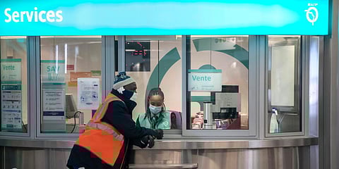 A subway maintainer (L) and a ticket seller wear masks to protect against the spread of the coronavirus as they gather at a metro station in Paris. (Photo| AP)