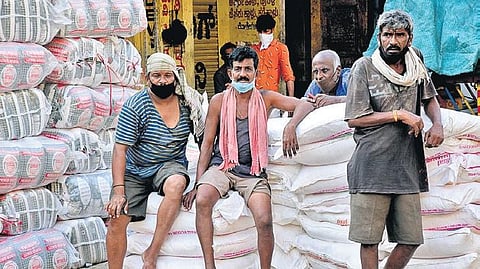 Daily wage labourers wait for work at a wholesale market in New Taragupet in Bengaluru on Wednesday | Nagaraja Gadekal