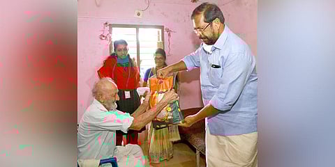 Mayor K Sreekumar distributing the food kits to the needy as part of Thanal Palliative Care project