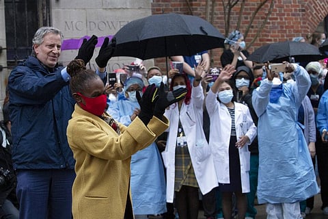Mayor Bill de Blasio and his wife Chirlane McCray applaud healthcare workers at Brooklyn's Kings County Hospital Center during a 7 o'clock ceremony during the coronavirus pandemic, Friday, April 24, 2020, in New York. (Photo | AP)