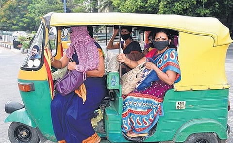 Social distancing goes for a toss as government employees cram themselves into an autorickshaw on their way to work in Bengaluru | Nagaraja Gadekal
