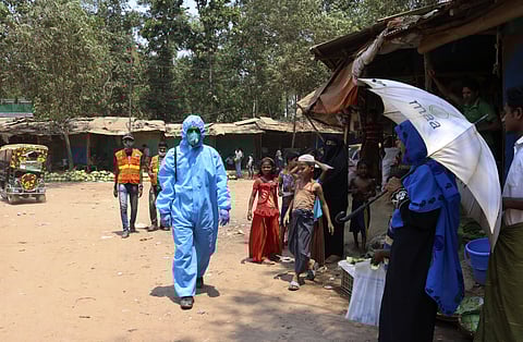 A health worker from an aid organization walks wearing a hazmat suit at the Kutupalong Rohingya refugee camp in Cox's Bazar, Bangladesh. (Photo | AP)