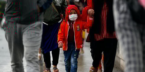 Nepalese people arrive to board a vehicle to go back to their village, during lockdown to prevent the spread of the new coronavirus in Bhaktapur, near Kathmandu. (Photo| AP)