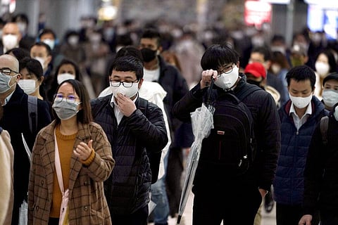 n this April 20, 2020, file photo, a station passageway is crowded with face mask wearing commuters during a rush hour, in Tokyo. (Photo | AP)